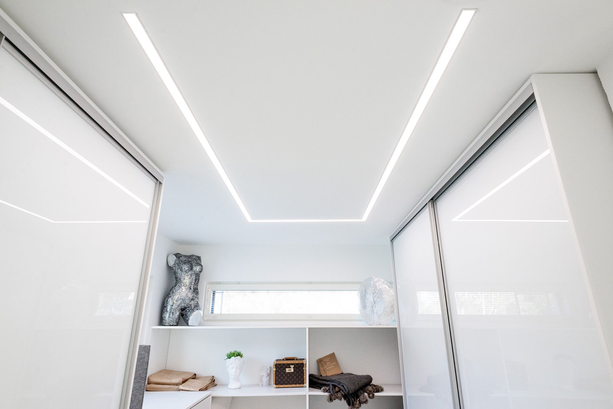 Wide recessed profile in the wardrobe with two LED strips, recessed profile shaped to the ceiling according to the room and the need. Ledstore.fi